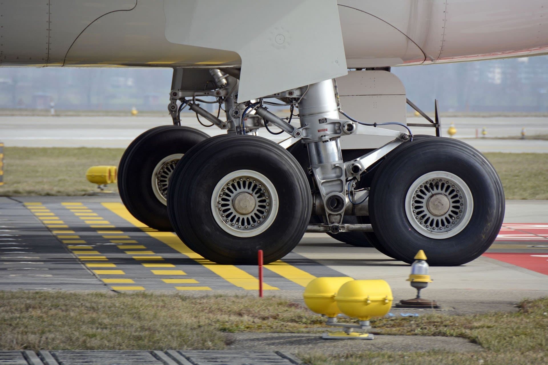 Close-up of aircraft landing gear, symbolizing air freight and engineering logistics.